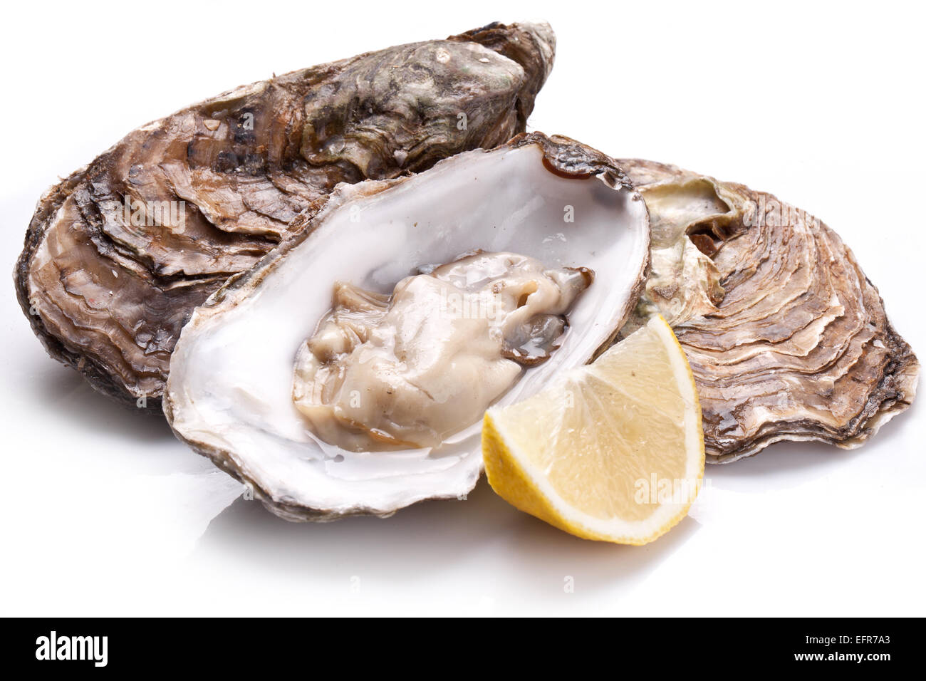 Raw oyster and lemon isolated on a white background. Stock Photo