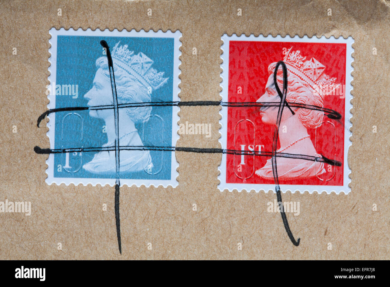 Two 1st class stamps with Queens head on envelope with lines crossed