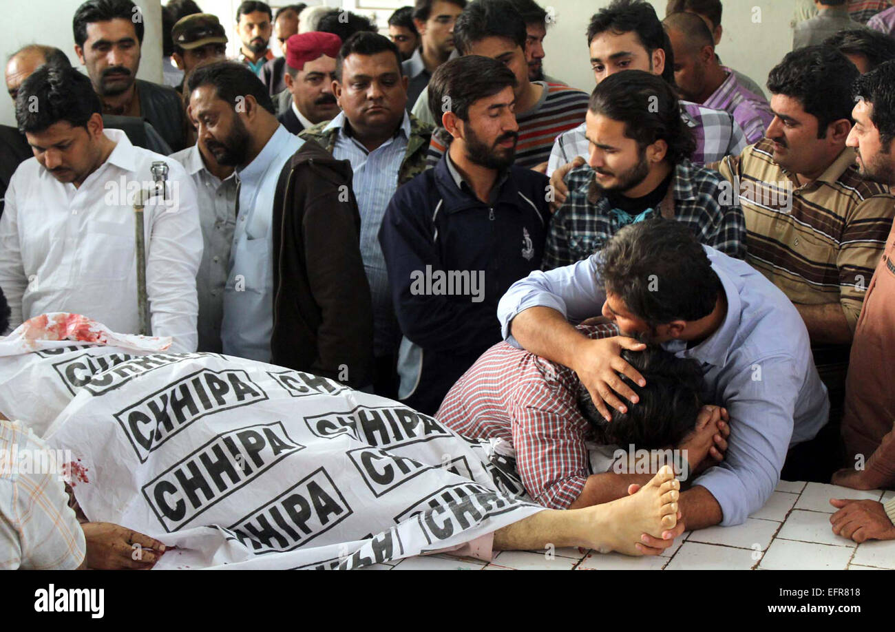 Sons of Ehsan Danish are reacting mourn on killing of their father at Jinnah Hospital in Karachi on Monday, February 09, 2015. Ehsan Danish was the president of Peoples Party ward-PS-118 and killed by unknown assailants near Aziz Bhatti Park in Karachi on Monday. Stock Photo