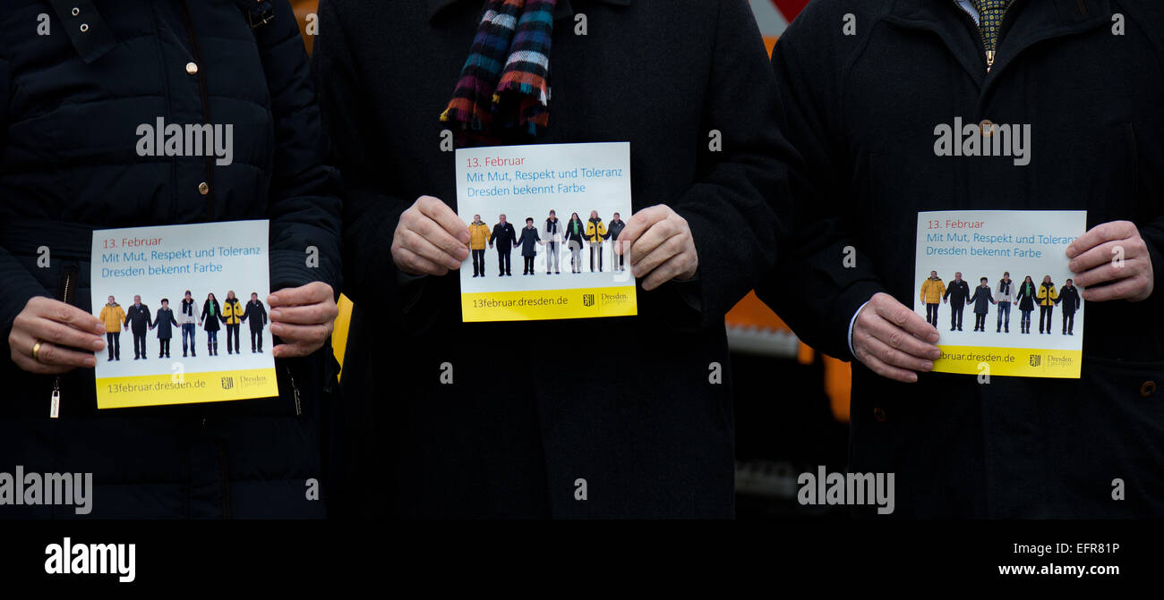 Dresden, Germany. 09th Feb, 2015. Board members and directors of the Dresden cleaning and drainage departments, the Dresden transport authority, and Drewag, the Dresden municipal works, place a sticker with the announcement for the human chain on 13 February 2015 on to vehicles of the above-mentioned companies and the central Drewag depot in Dresden, Germany, 09 February 2015. The sticker calls on residents and guests of Dresden to participate in the human chain on 13 February 2105 at 6PM. Photo: ARNO BURGI/dpa/Alamy Live News Stock Photo