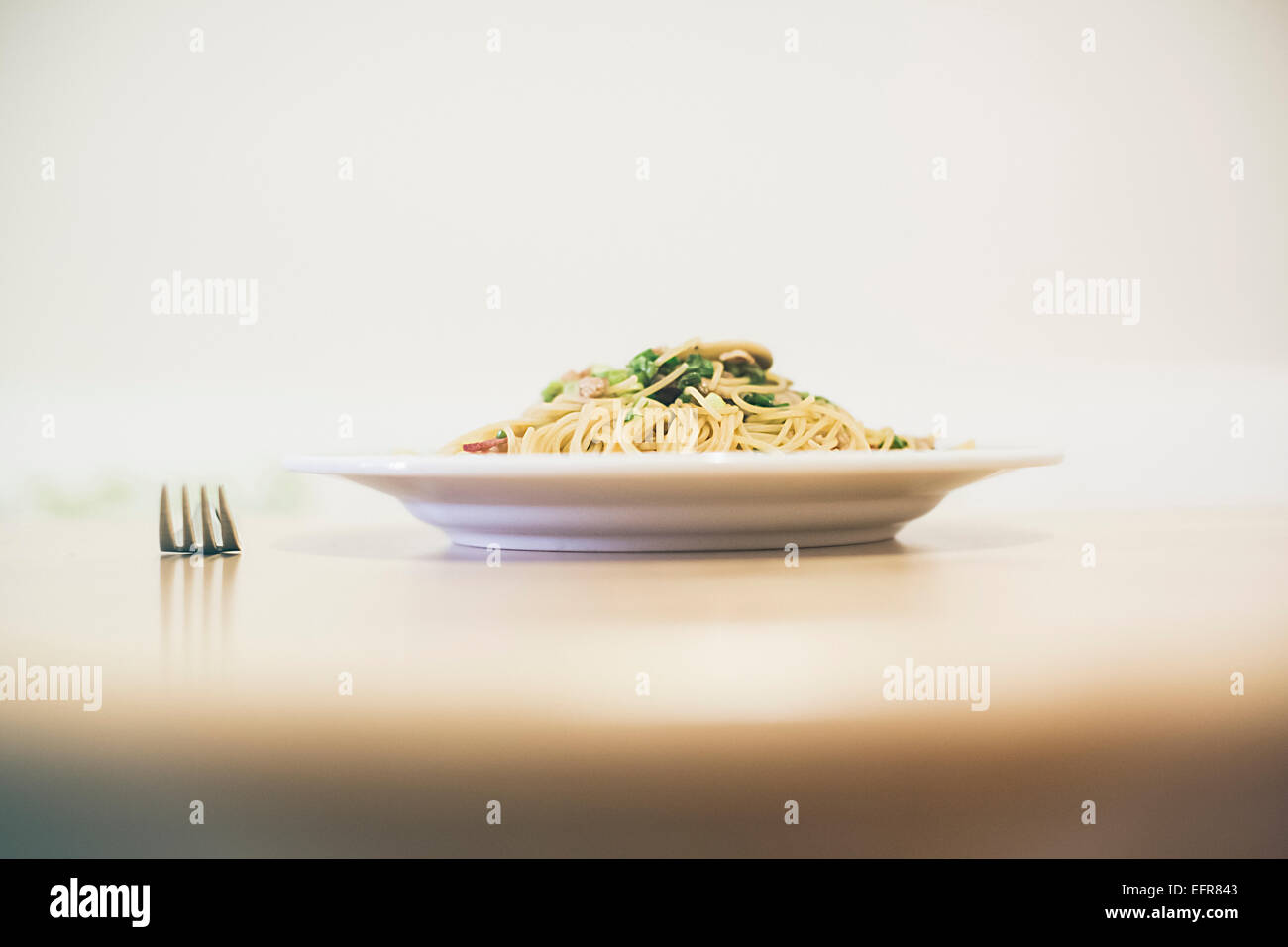 Noodle meal on table with fork Stock Photo Alamy