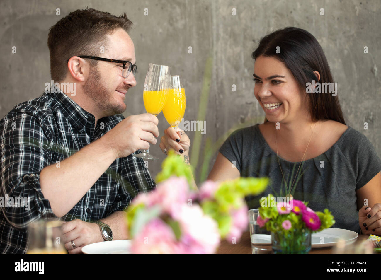 Man and woman clinking glasses Stock Photo
