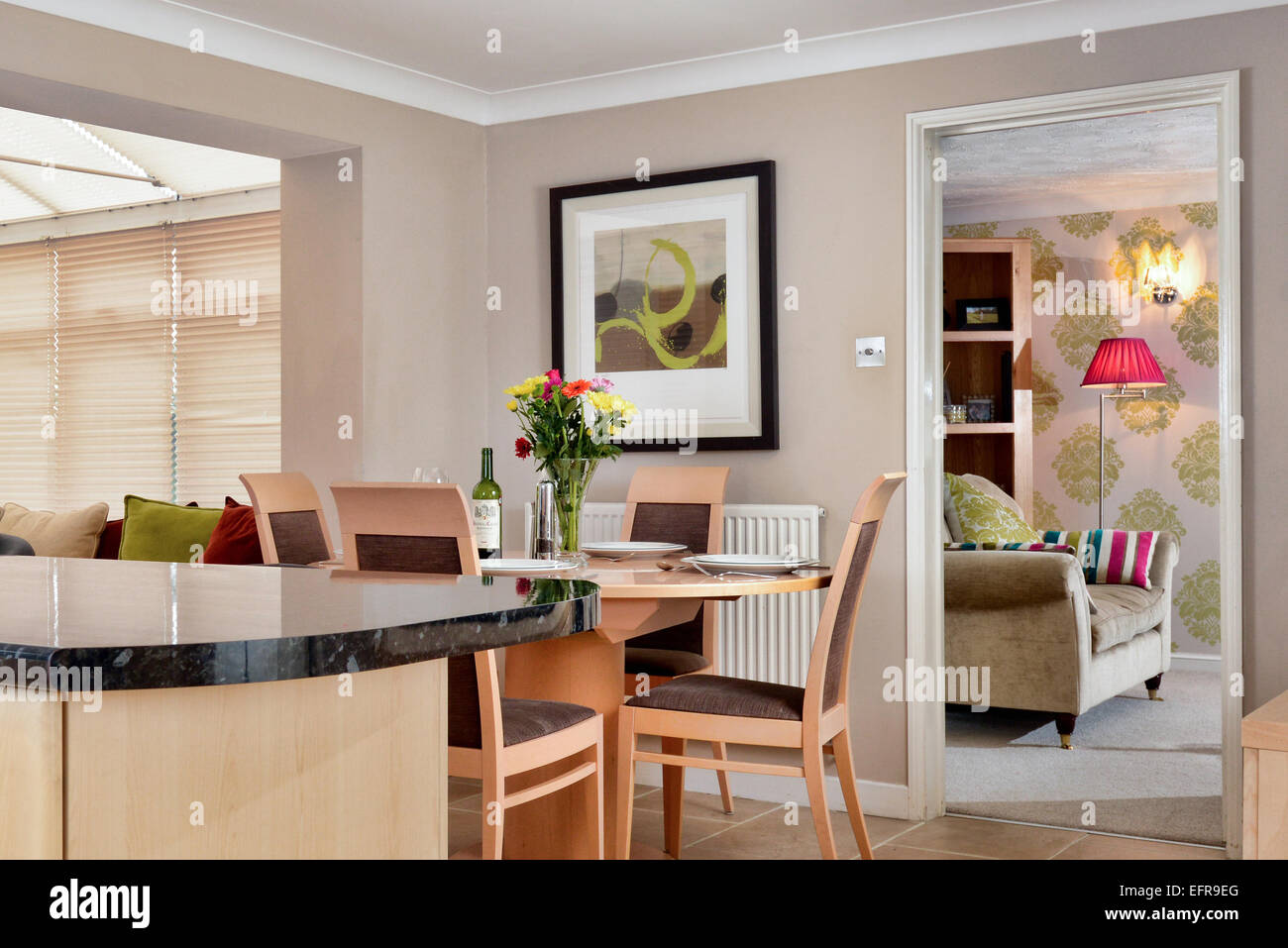 An interior of a modern UK home showing the kitchen, dinning space & it's connection to the living room Stock Photo