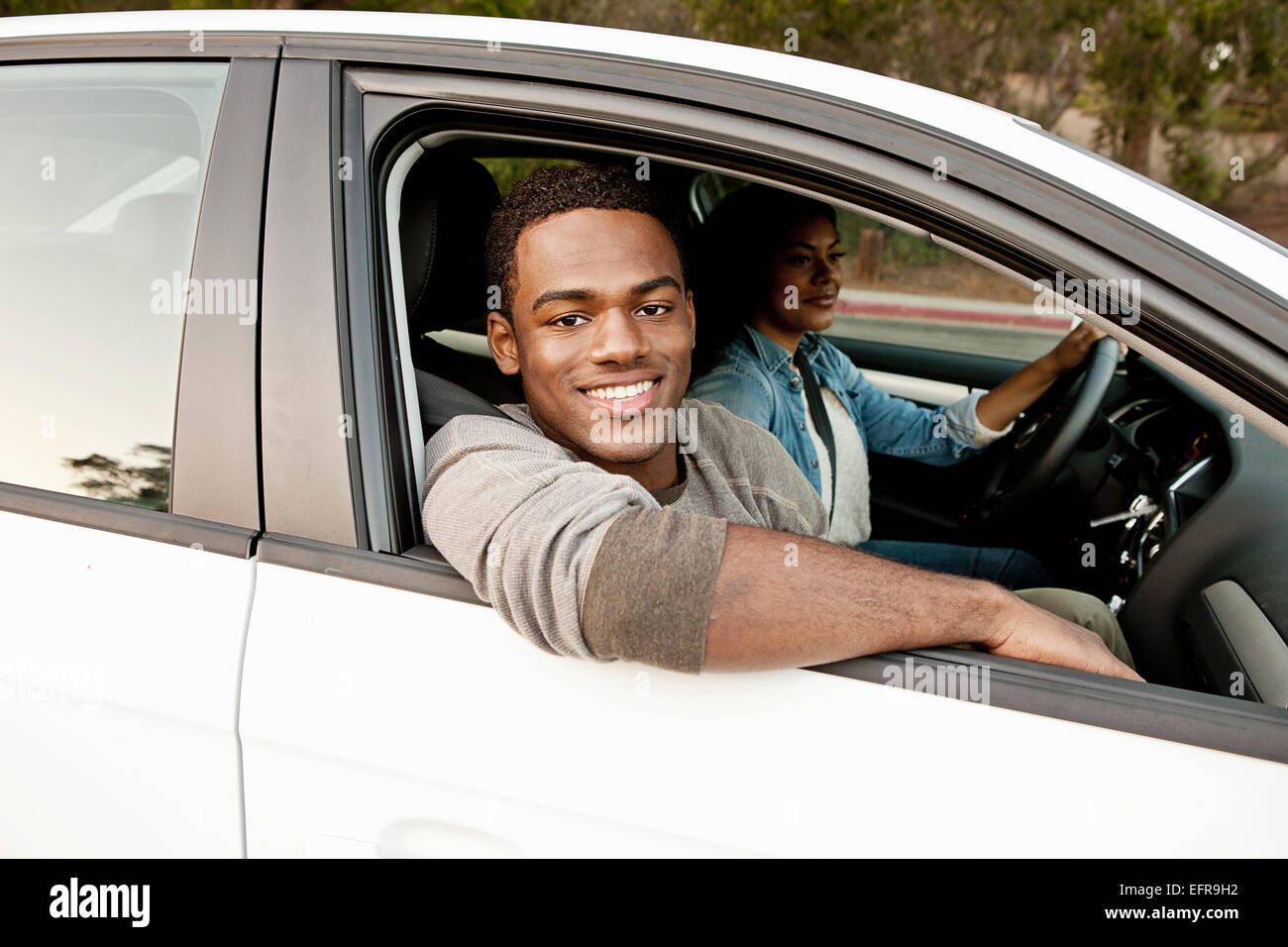 Portrait of young man looking out of of car window Stock Photo