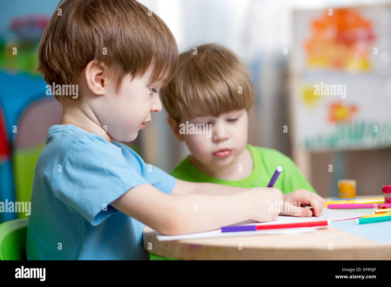 children painting in nursery at home Stock Photo