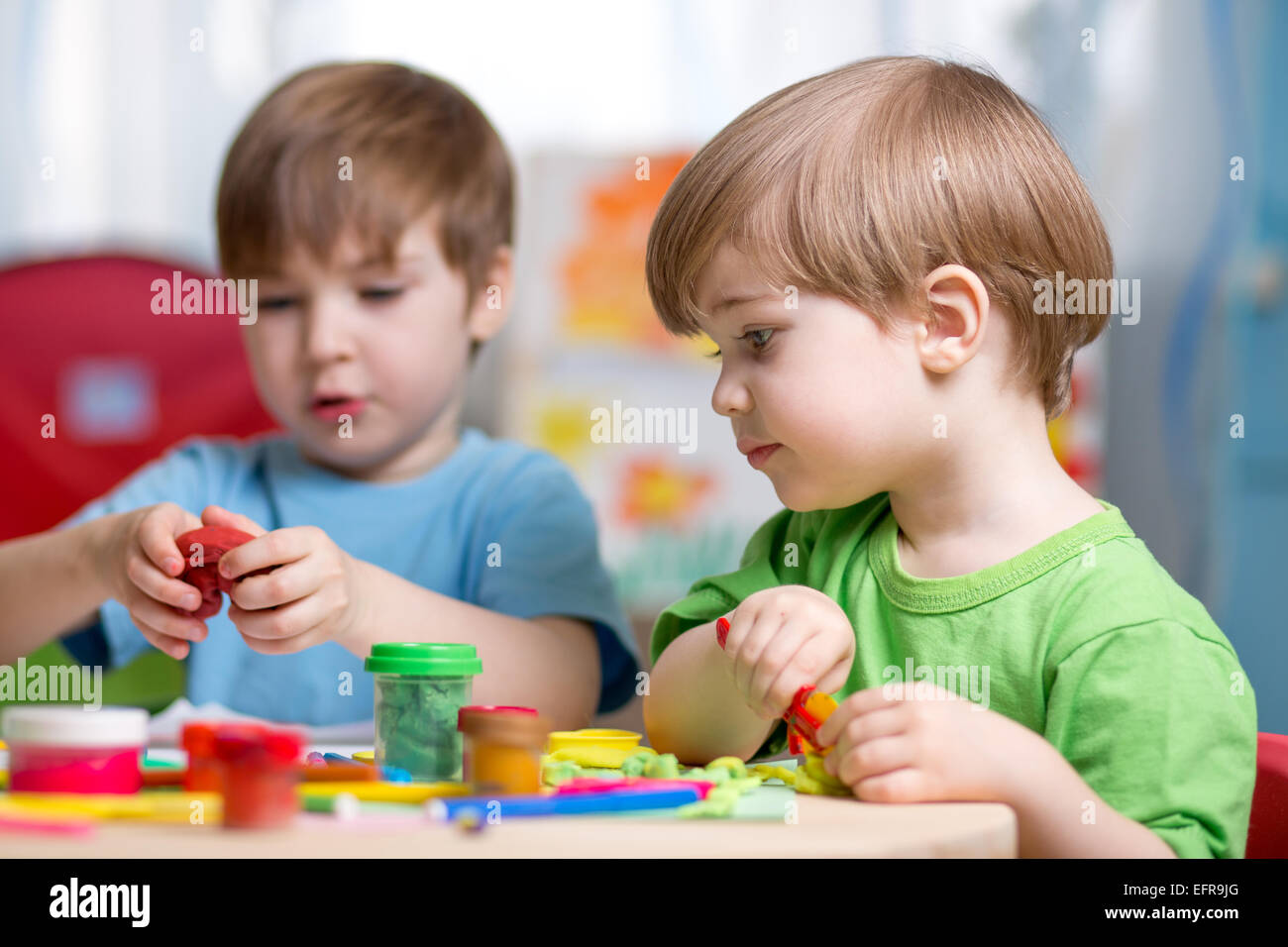 kids with play clay at home Stock Photo