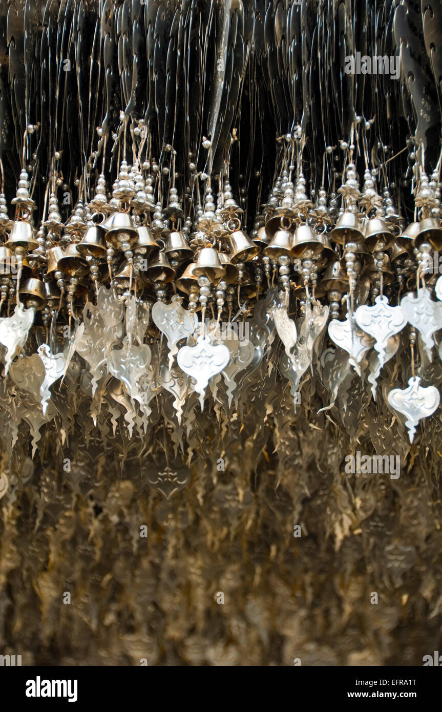 Vertical view of lucky charms hanging at Wat Rong Khun, the White Temple, in Chiang Rai. Stock Photo