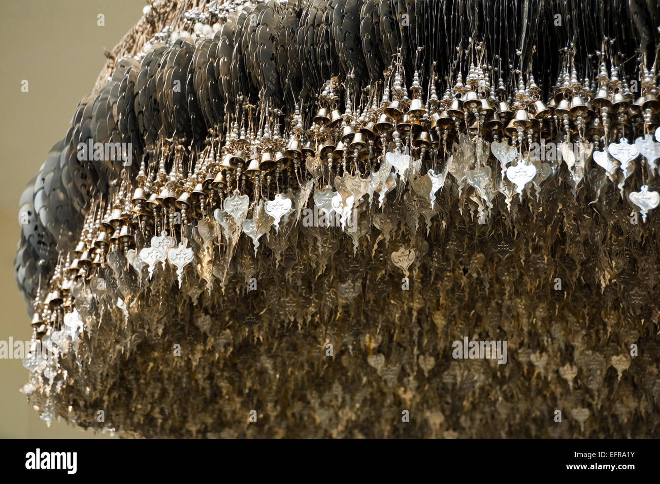 Horizontal view of lucky charms hanging at Wat Rong Khun, the White Temple, in Chiang Rai. Stock Photo