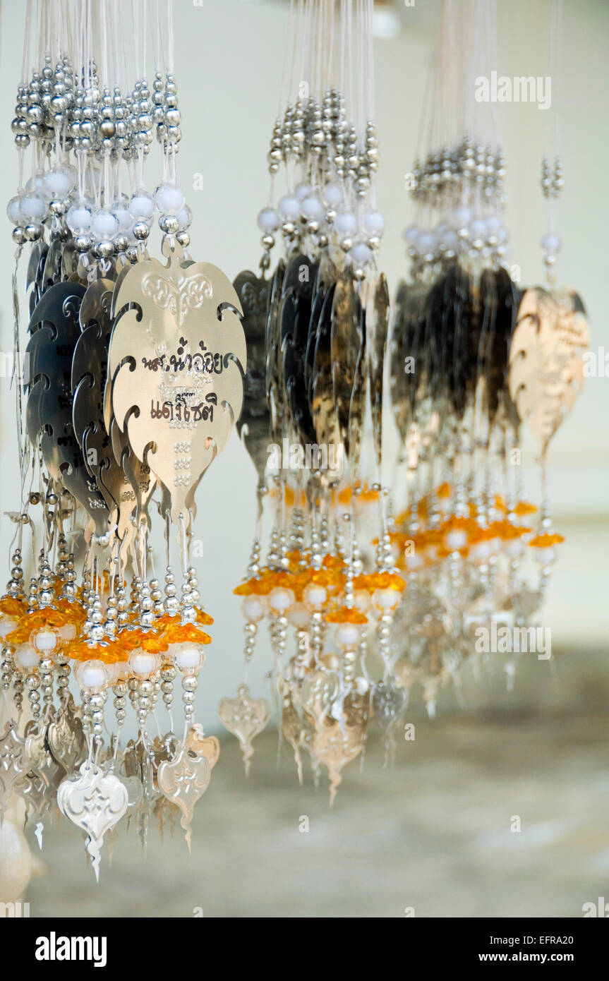Vertical view of lucky charms hanging at Wat Rong Khun, the White Temple, in Chiang Rai. Stock Photo