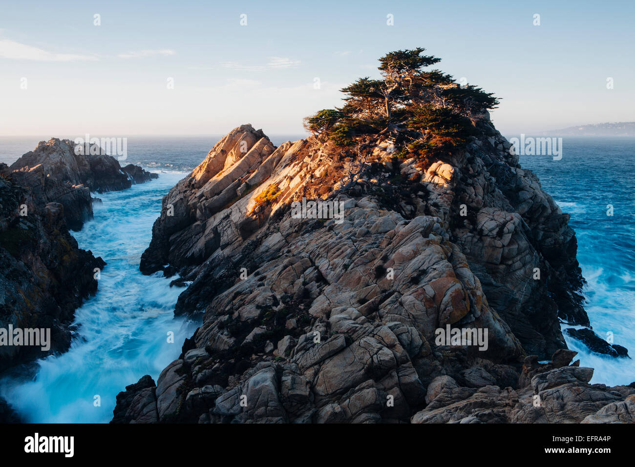 Dramatic cliffs and coastline at dusk in the Point Lobos State Reserve on the Pacific coastline. White foaming water. Stock Photo