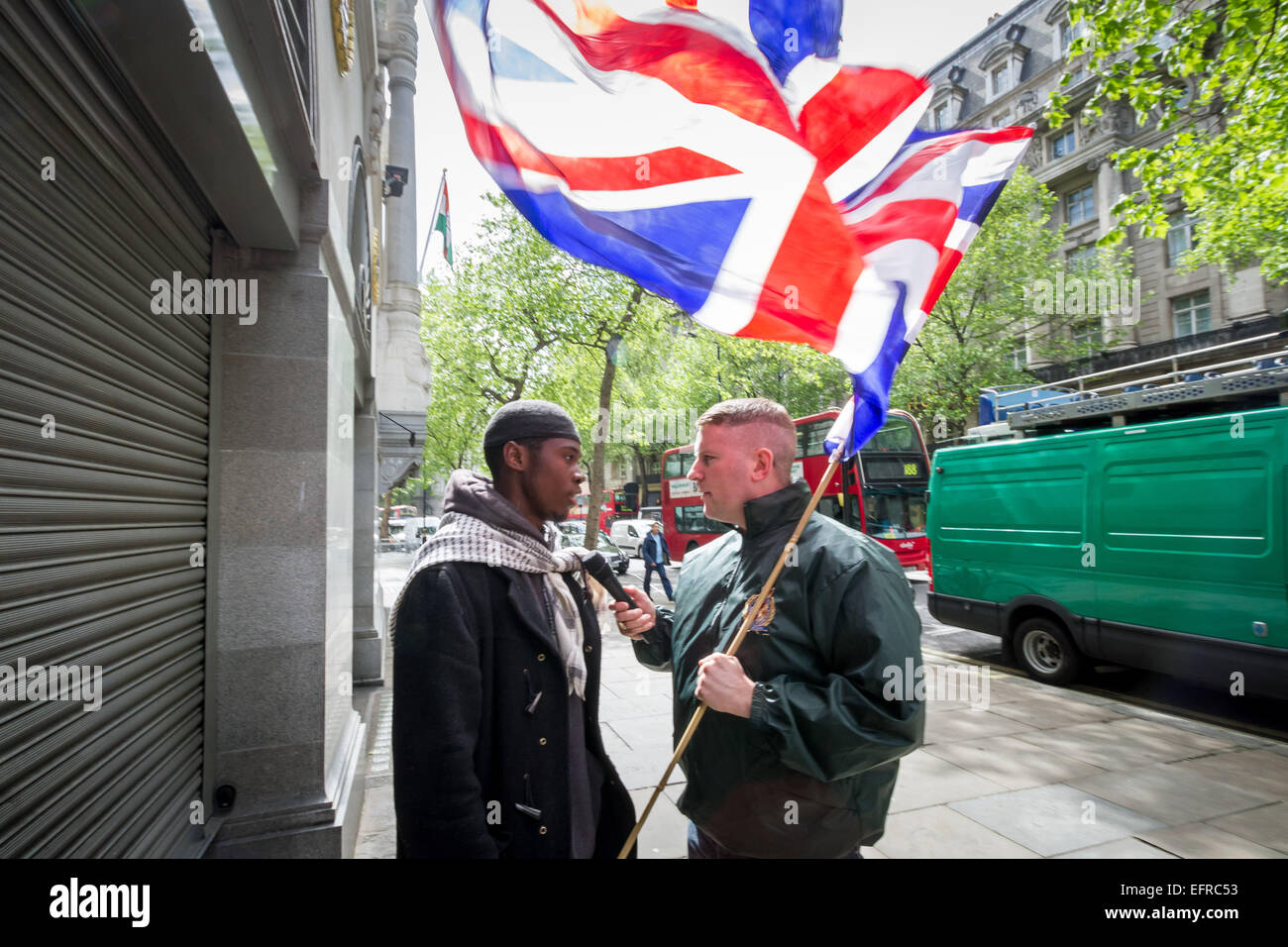 Brustchom Ziamani (L) pictured here 9th May 2014 outside the Indian High Commission in London being confronted by Paul Golding (R) of Britain First Nationalist movement.  Brustchom Ziamani, 19, has been remanded in custody after appearing in court to face terror allegations. Ziamani, of Camberwell, south-east London, has been accused of "engaging in conduct in preparation of terrorist acts" on or before 19th August 2014. Mr Ziamani was arrested in east London on Tuesday 19th Aug 2014. He is currently on trial at Old Bailey court. Stock Photo