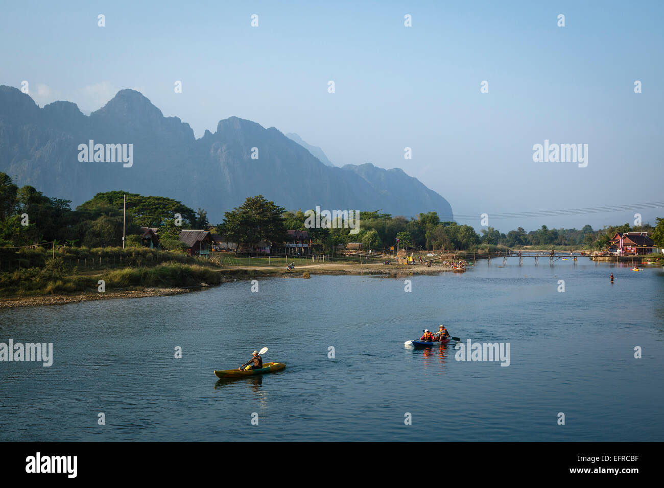 People kayaking at Nam Song river, Vang Vieng, Laos. Stock Photo
