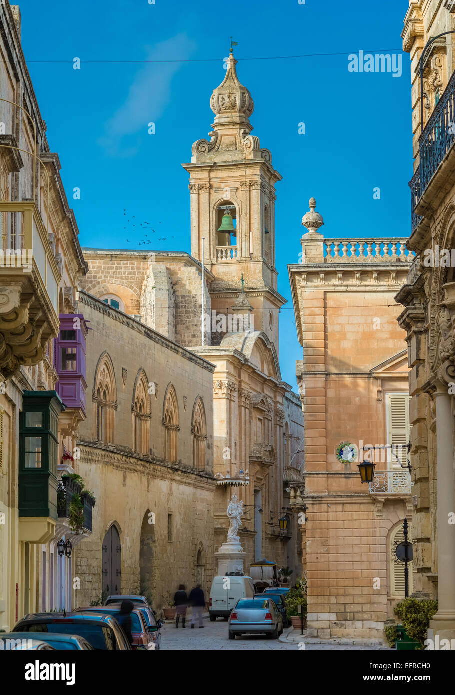 Maltese narrow street in Mdina with stone buildings in traditional architecture. Stock Photo