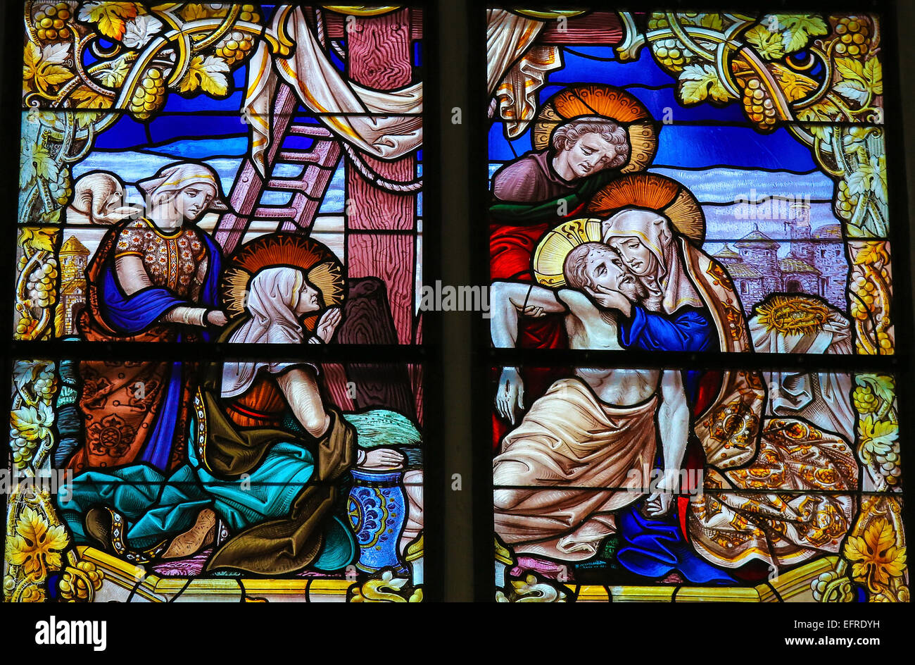 Stained Glass window, depicting Jesus taken from the Cross into Mother Mary's arms on Good Friday Stock Photo
