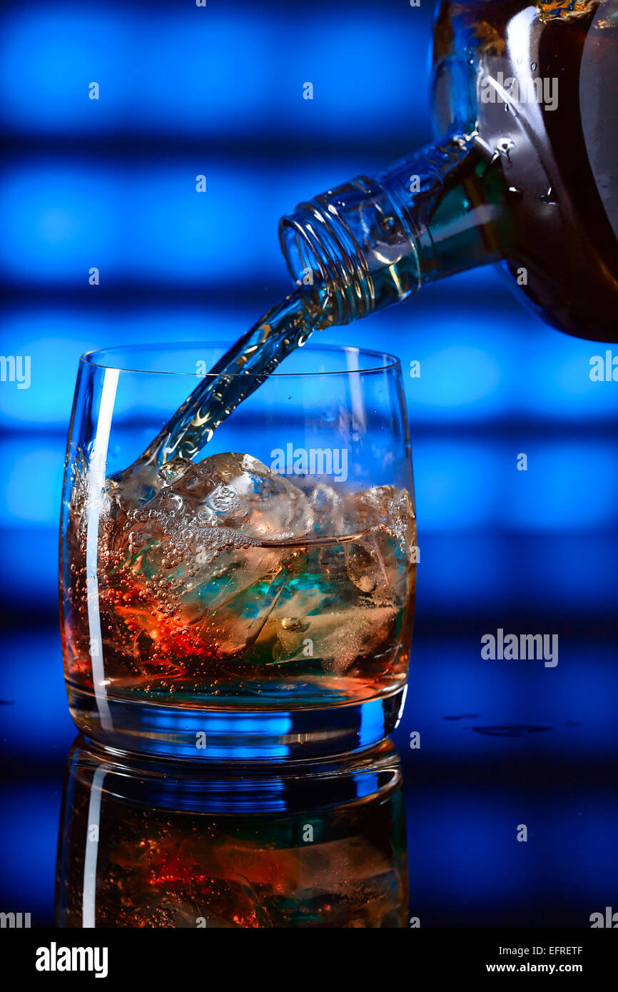 whiskey with ice on a glass table Stock Photo Alamy
