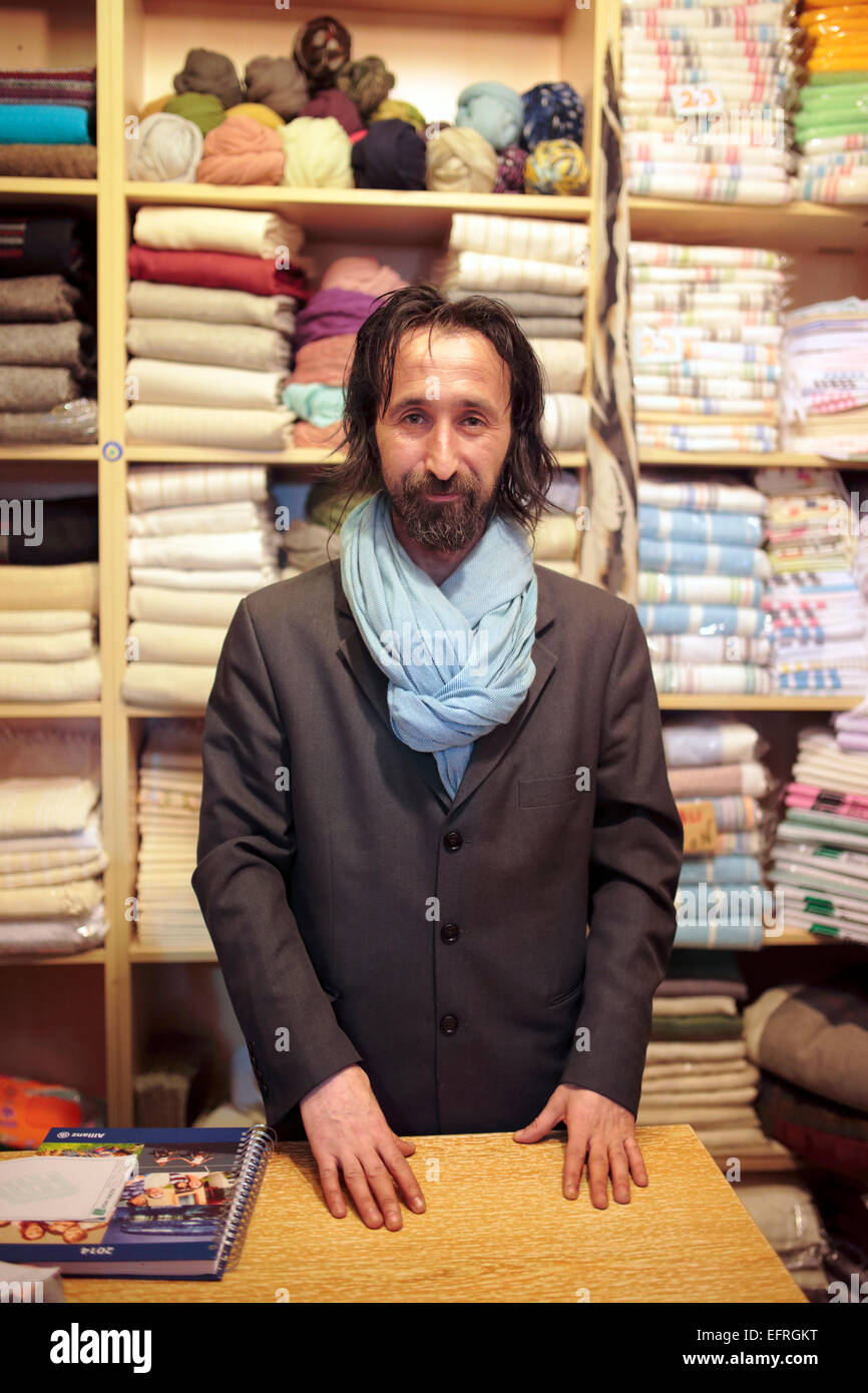 Vendor in textile shop, Grand Bazaar, Istanbul, Turkey Stock Photo