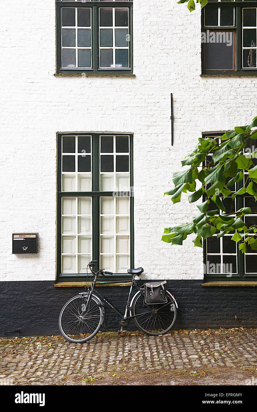 Bicycle Parked agianst a whtie Building, Bruges, Belgium Stock Photo