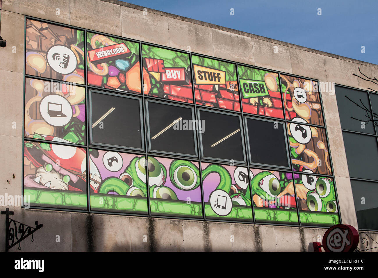 We Buy Your Stuff For Cash, vibrant graffiti-style mural on CEX shop, Fitzroy Street, Cambridge, UK Stock Photo