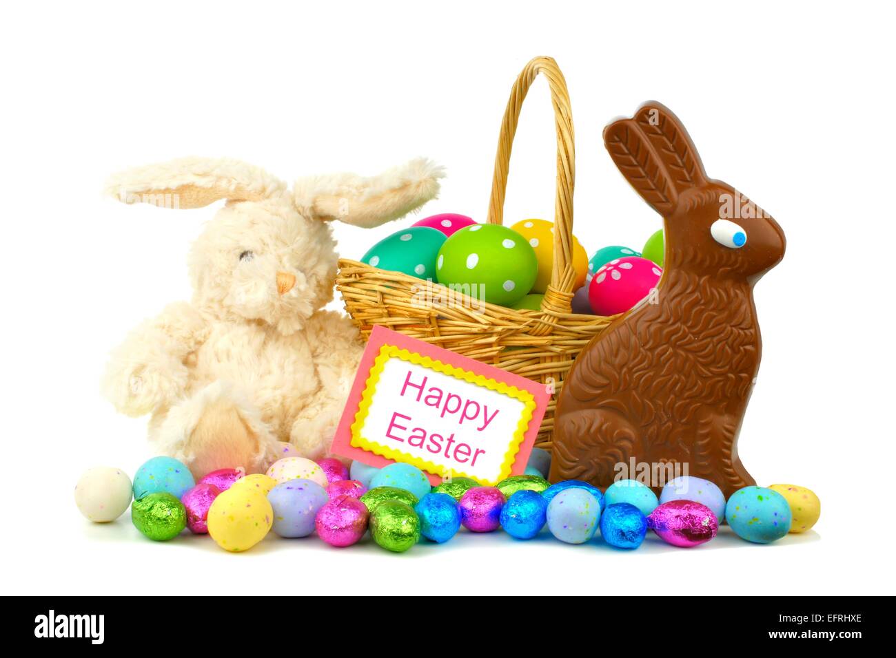 Happy Easter card with Easter basket, candies and toy bunny over white Stock Photo