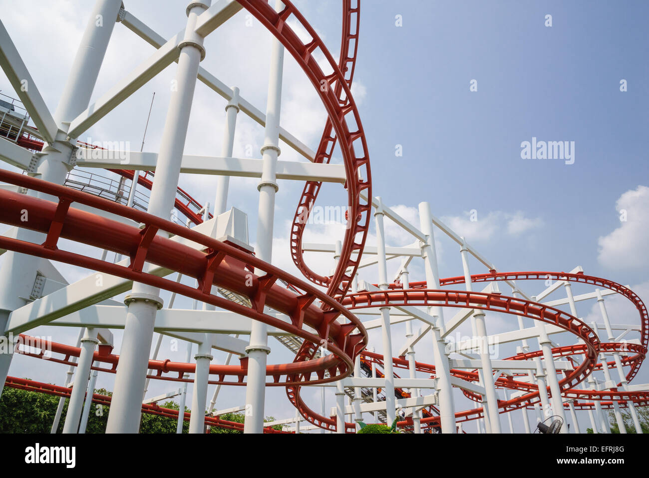 round turn of red roller coaster rail in amusement park look exiting and fun for all visitors to play Stock Photo