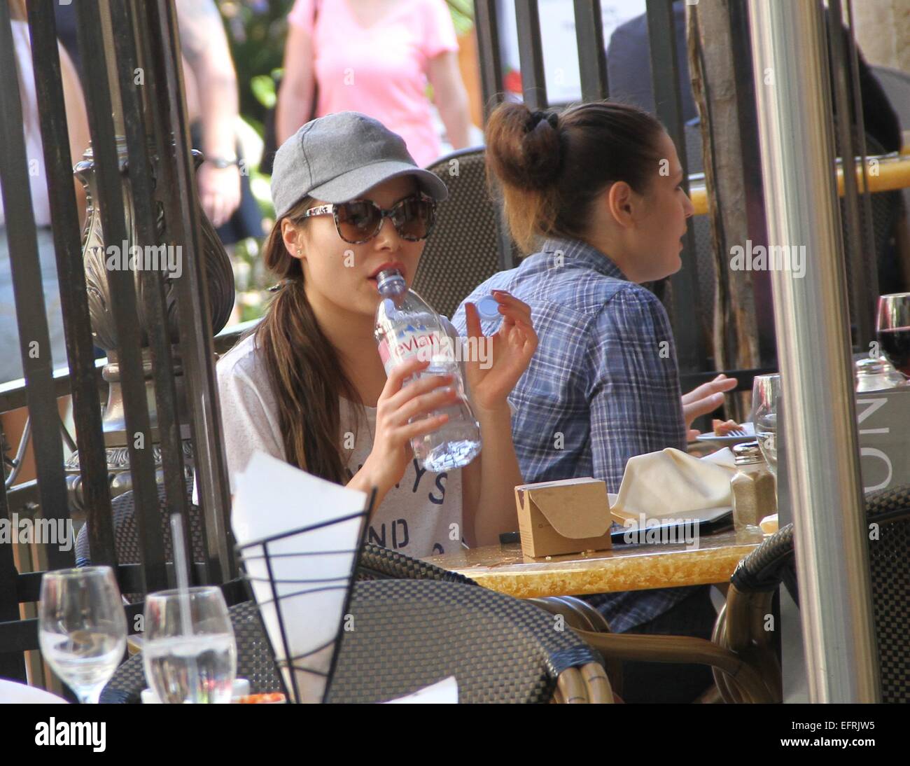 Miranda Cosgrove wearing a t-shirt with the logo 'Always and Forever'  stops for lunch and drinks from a bottle of water before shopping at The Grove in Hollywood  Featuring: Miranda Cosgrove Where: Los Angeles, California, United States When: 07 Aug 2014 Stock Photo