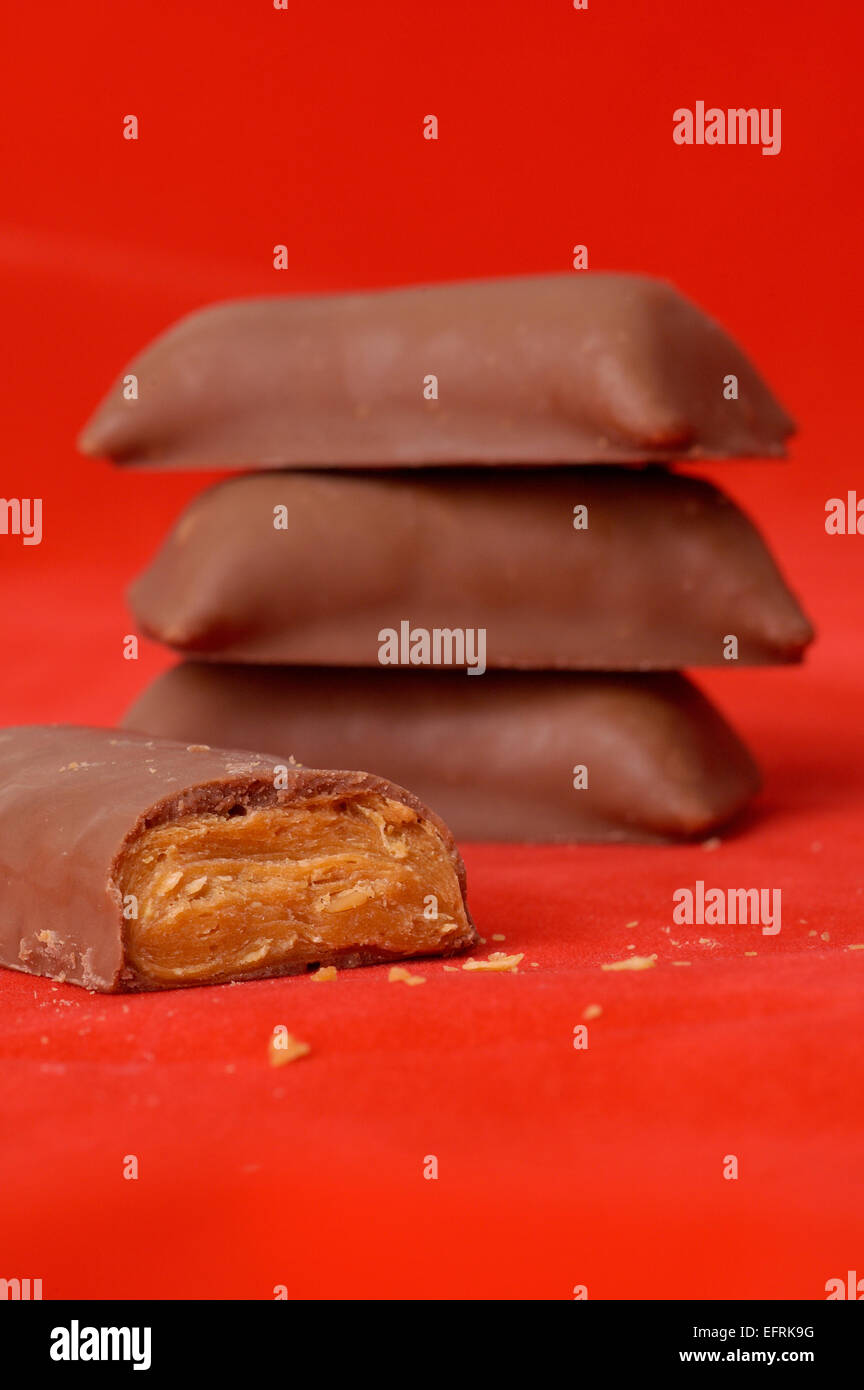 Unwrapped pieces of fun size Butterfinger candy. Stock Photo