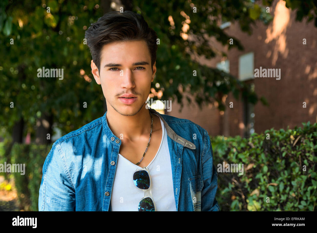 Handsome young man's portrait outdoor under tree Stock Photo - Alamy