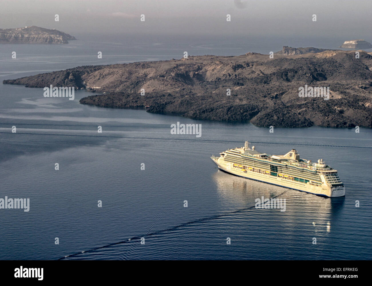 Santorini, Greece. 29th Sep, 2004. The Royal Caribbean International cruise ship Brilliance of the Seas sails past the volcanic island of Nea Kamini in the Santorini lagoon caldera (volcanic crater). The southernmost member of the Cyclades island group, colorful Santorini is a favorite tourist and cruise ship destination. © Arnold Drapkin/ZUMA Wire/Alamy Live News Stock Photo