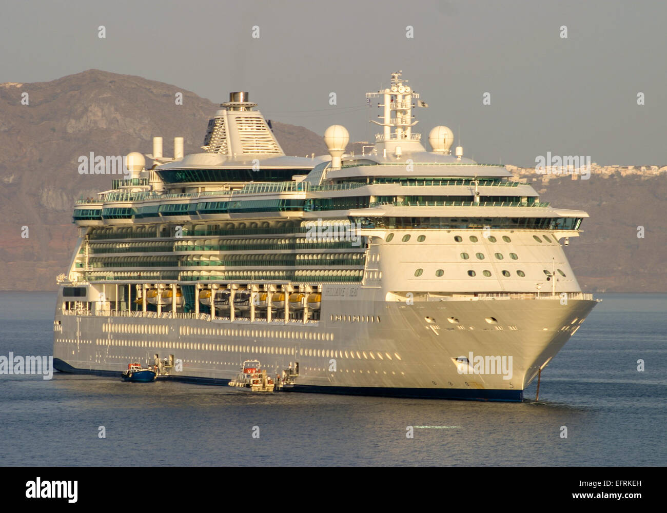 Santorini, Greece. 29th Sep, 2004. The Royal Caribbean International cruise ship Brilliance of the Seas at anchor in the Santorini lagoon caldera (volcanic crater). The southernmost member of the Cyclades island group, colorful Santorini is a favorite tourist and cruise ship destination. © Arnold Drapkin/ZUMA Wire/Alamy Live News Stock Photo