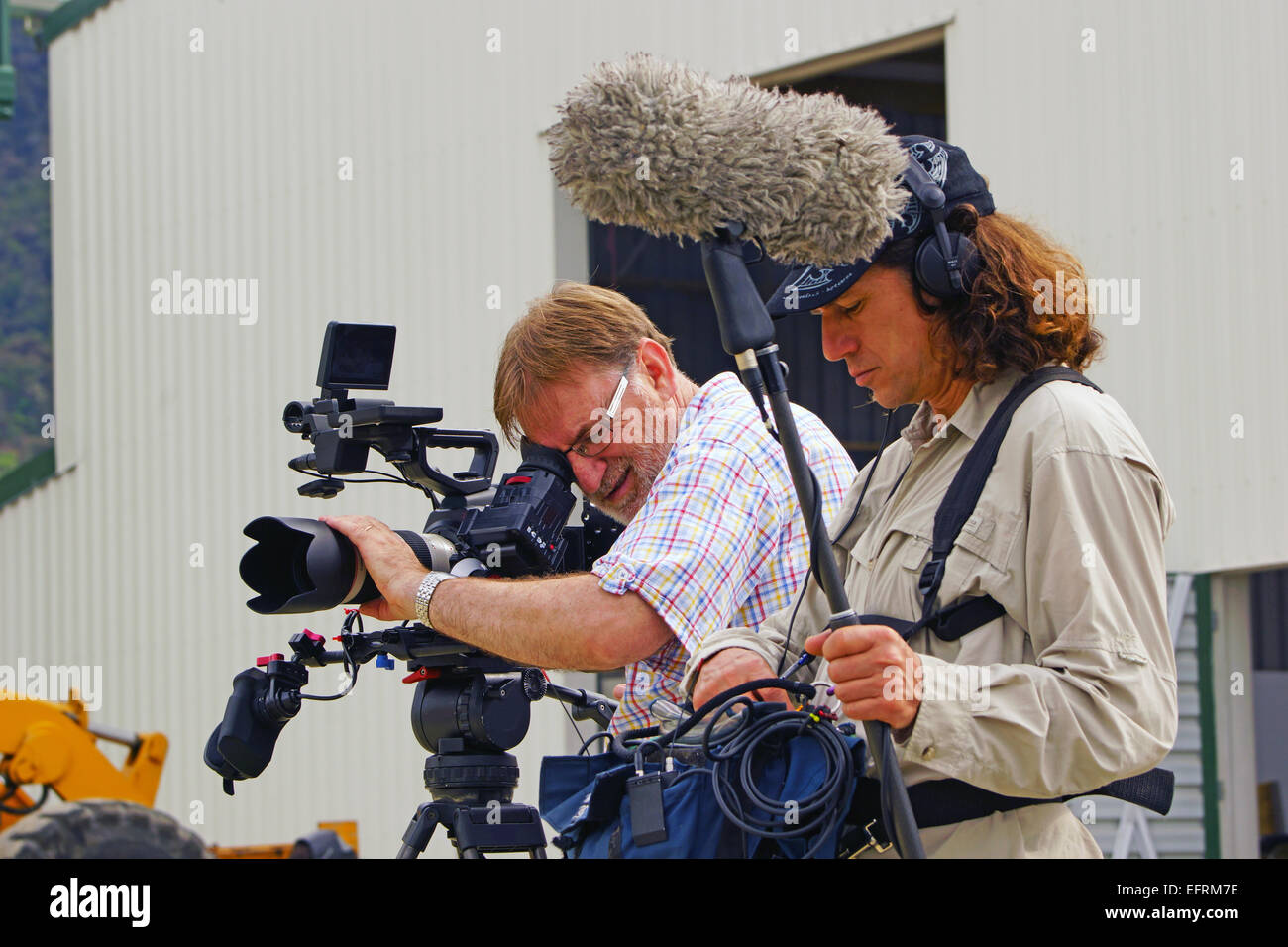 A documentary cameraman and his sound recordist at work on location Stock Photo