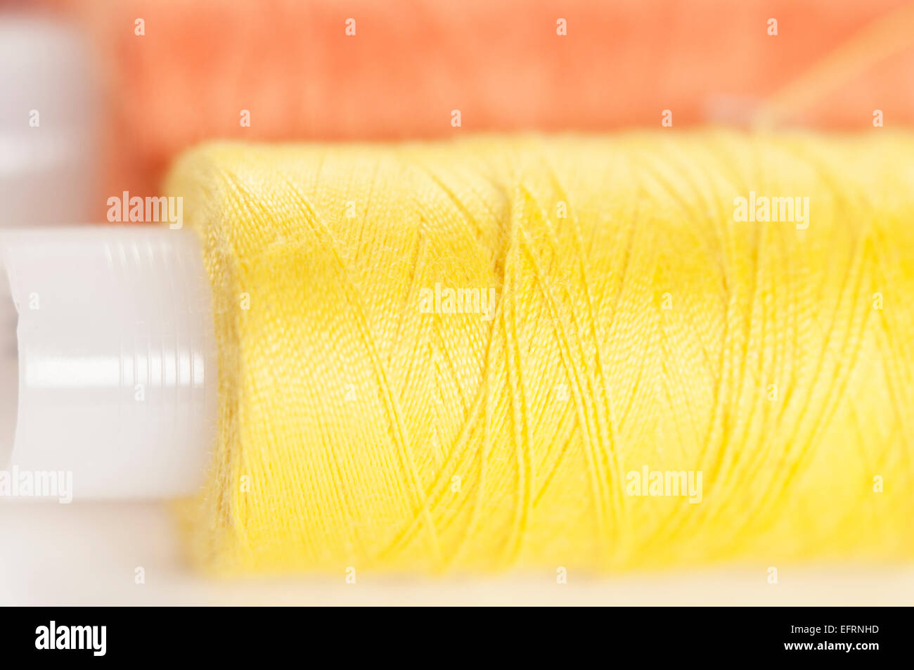 Sewing strings on a light background, macro shot, local focus Stock Photo