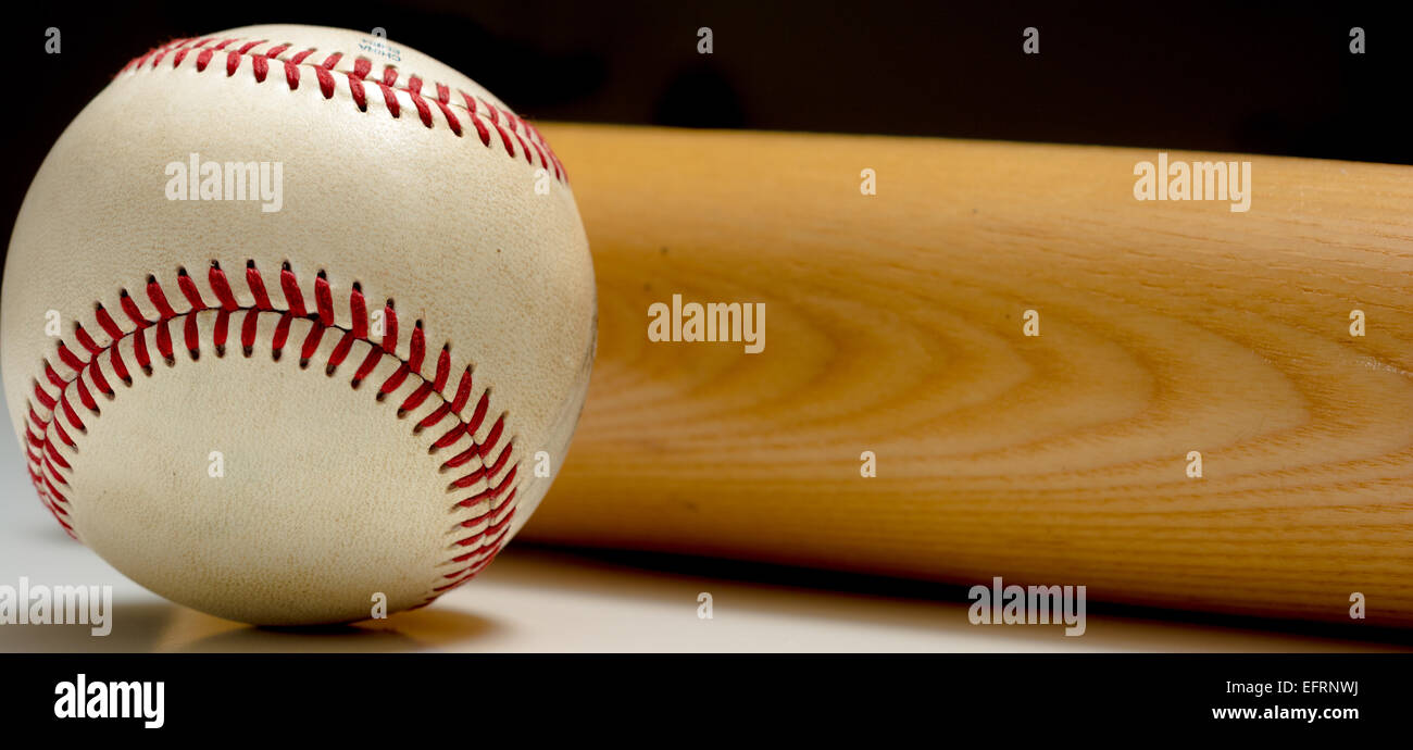 A leather baseball and wooden bat on a white background Stock Photo
