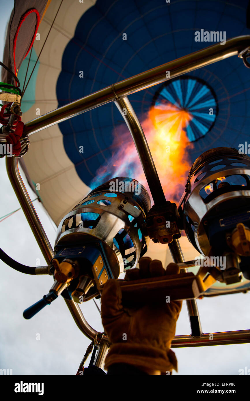 Low angle view of pilot inflating hot air balloon with gas burner, close up Stock Photo