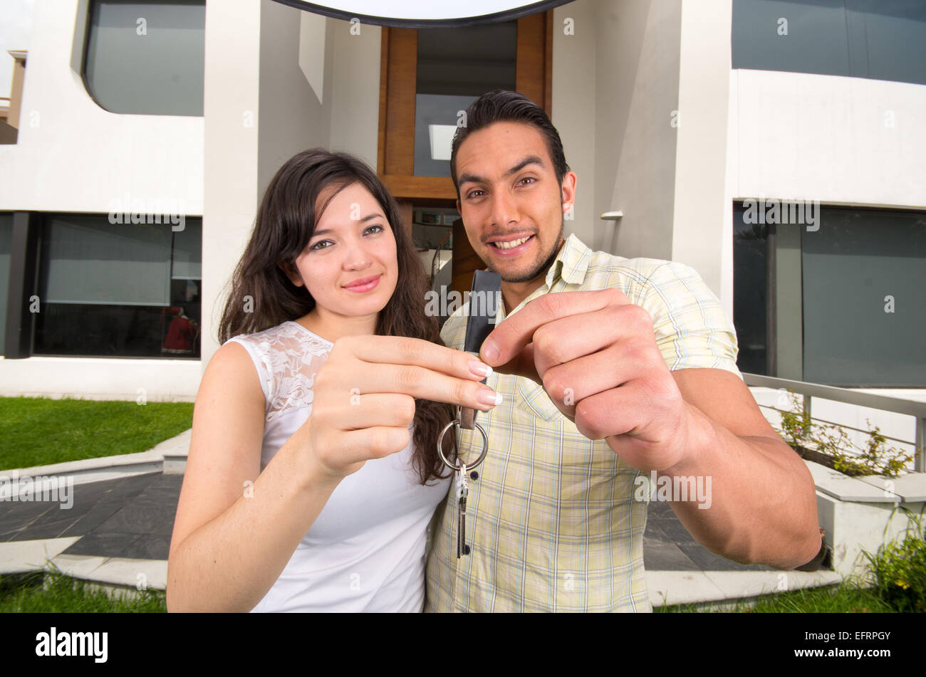 happy couple holding key to their new house Stock Photo - Alamy