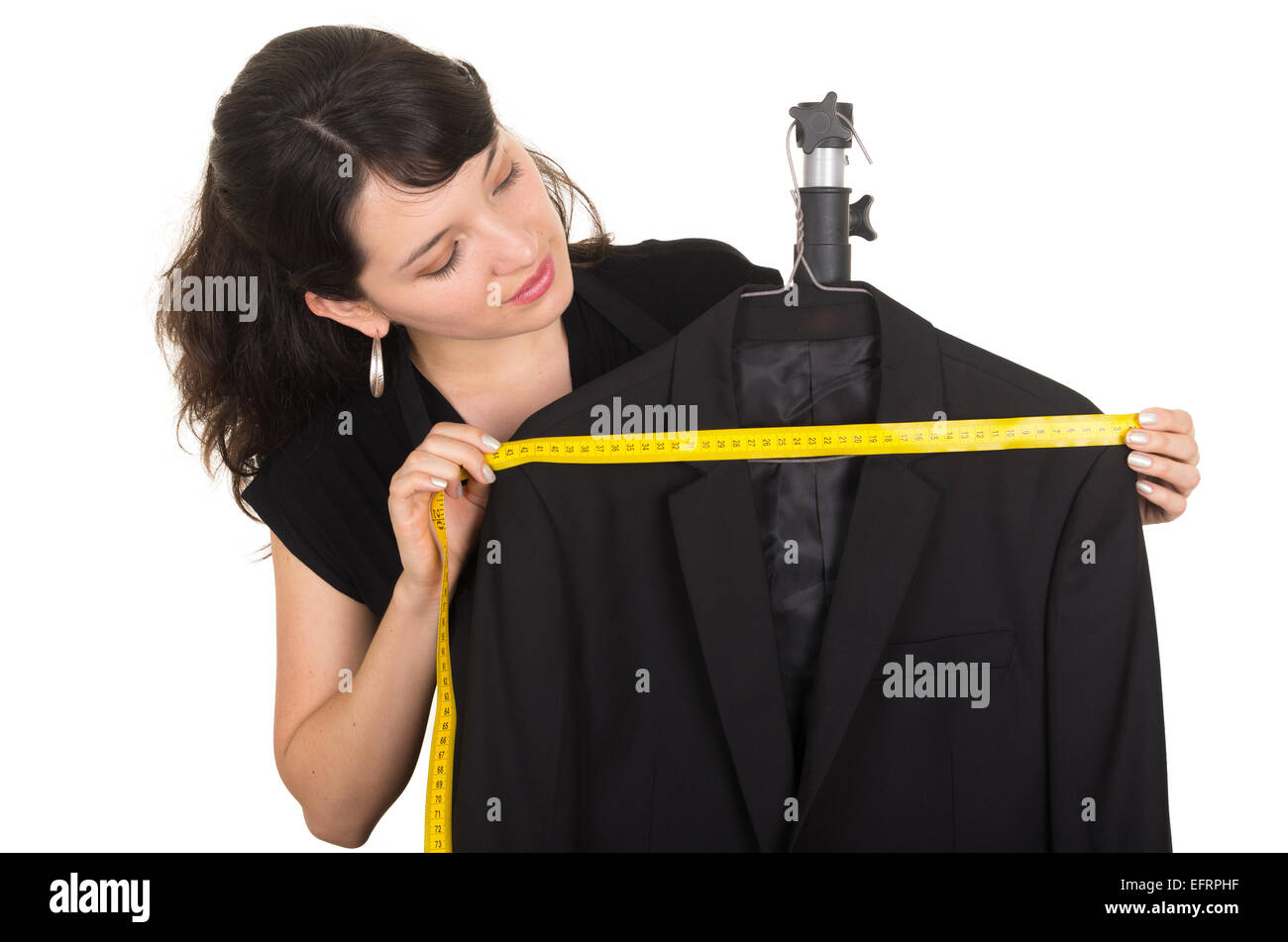 beautiful young woman tailor measuring a black suit Stock Photo - Alamy