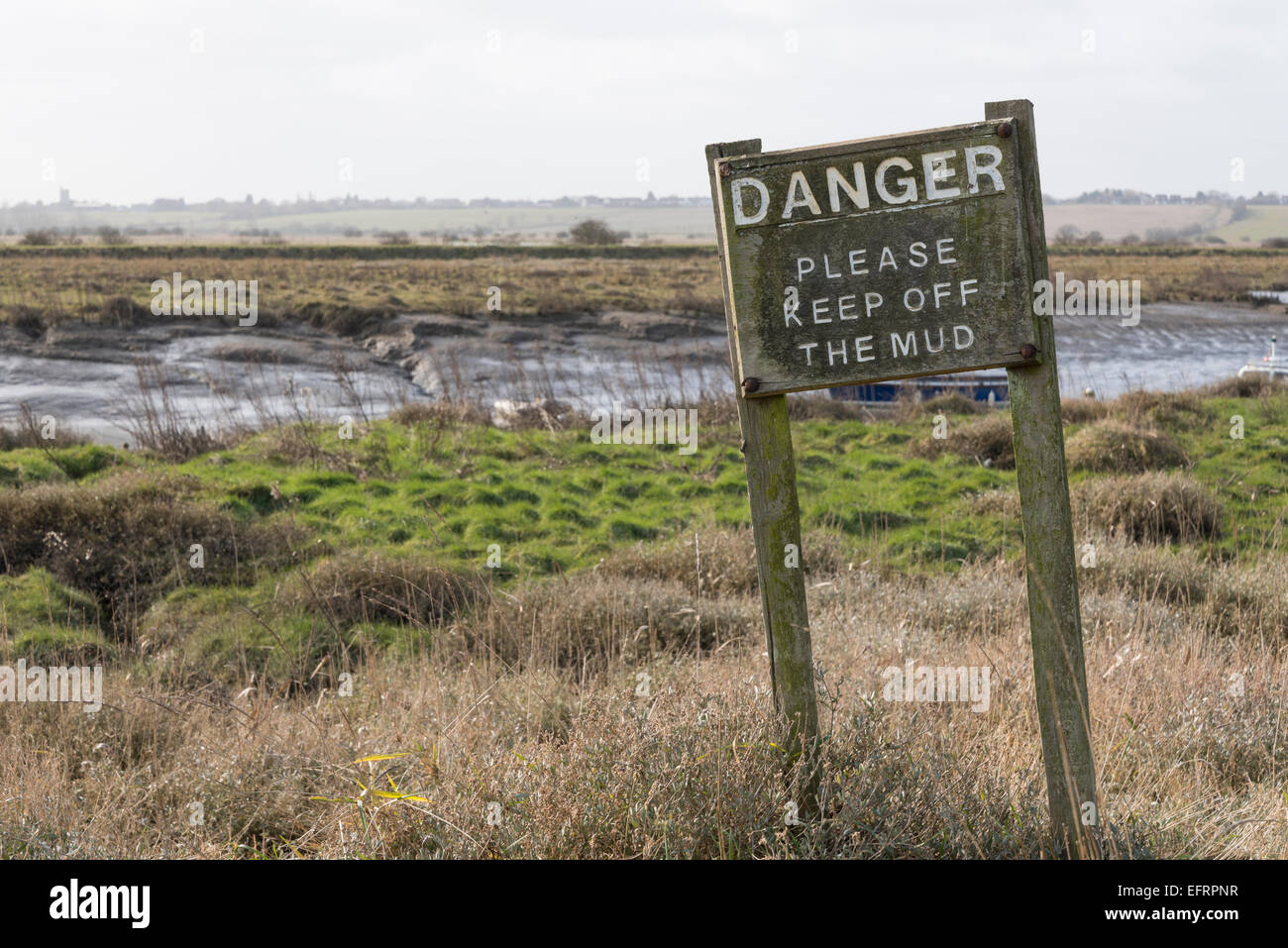A sign warning of the danger of mud at Vange Creek, Essex Stock Photo