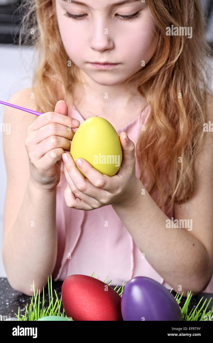 Adolescent girl painting Easter eggs Stock Photo