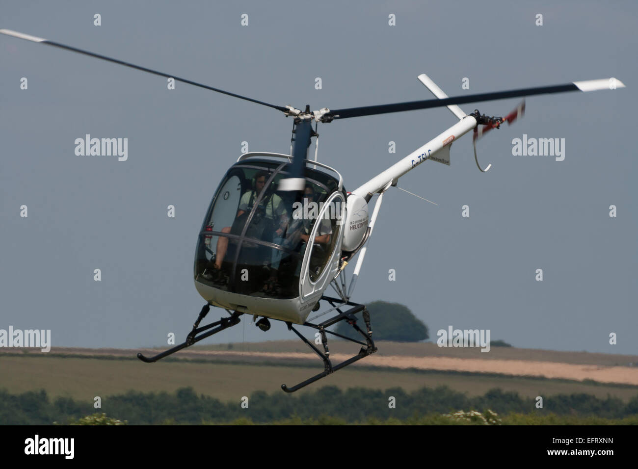 Photograph of a Schweizer 300 helicopter at Compton Abbas airfield Stock Photo
