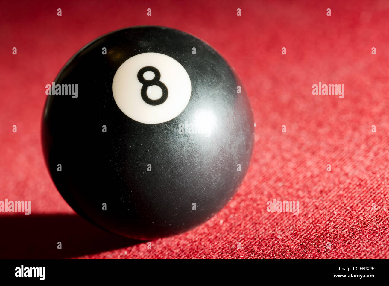 Billards pool or snooker game. The black eight ball. Red cloth table Stock Photo
