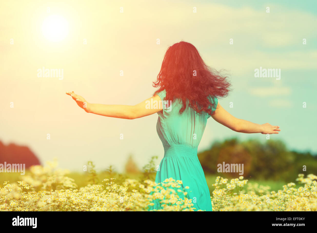Young happy girl walking on the flower meadow Stock Photo - Alamy