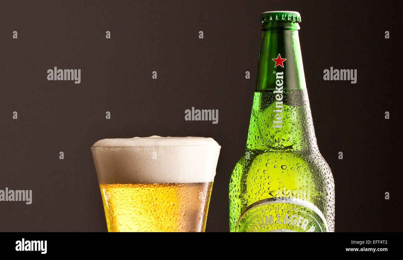 Heineken Lager bottle with glass and frothy head. Both with chilled effect Stock Photo
