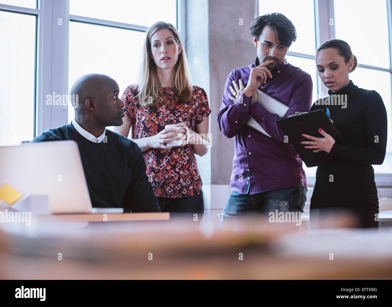 Group of multi ethnic executives working on a project. Business people analyzing statistic. Stock Photo