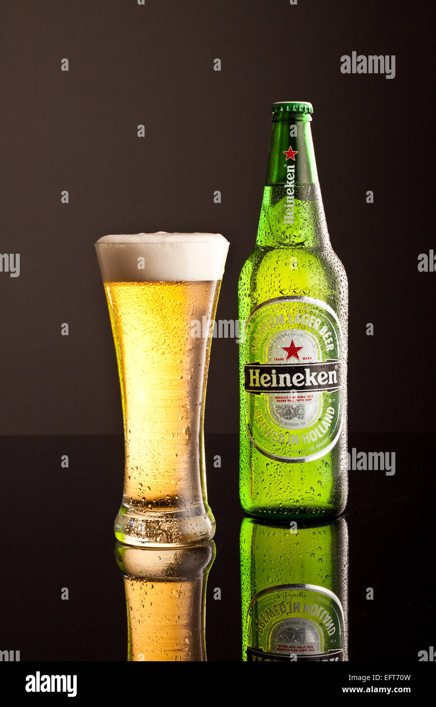 Heineken Lager bottle with glass and frothy head with chilled effect Stock Photo