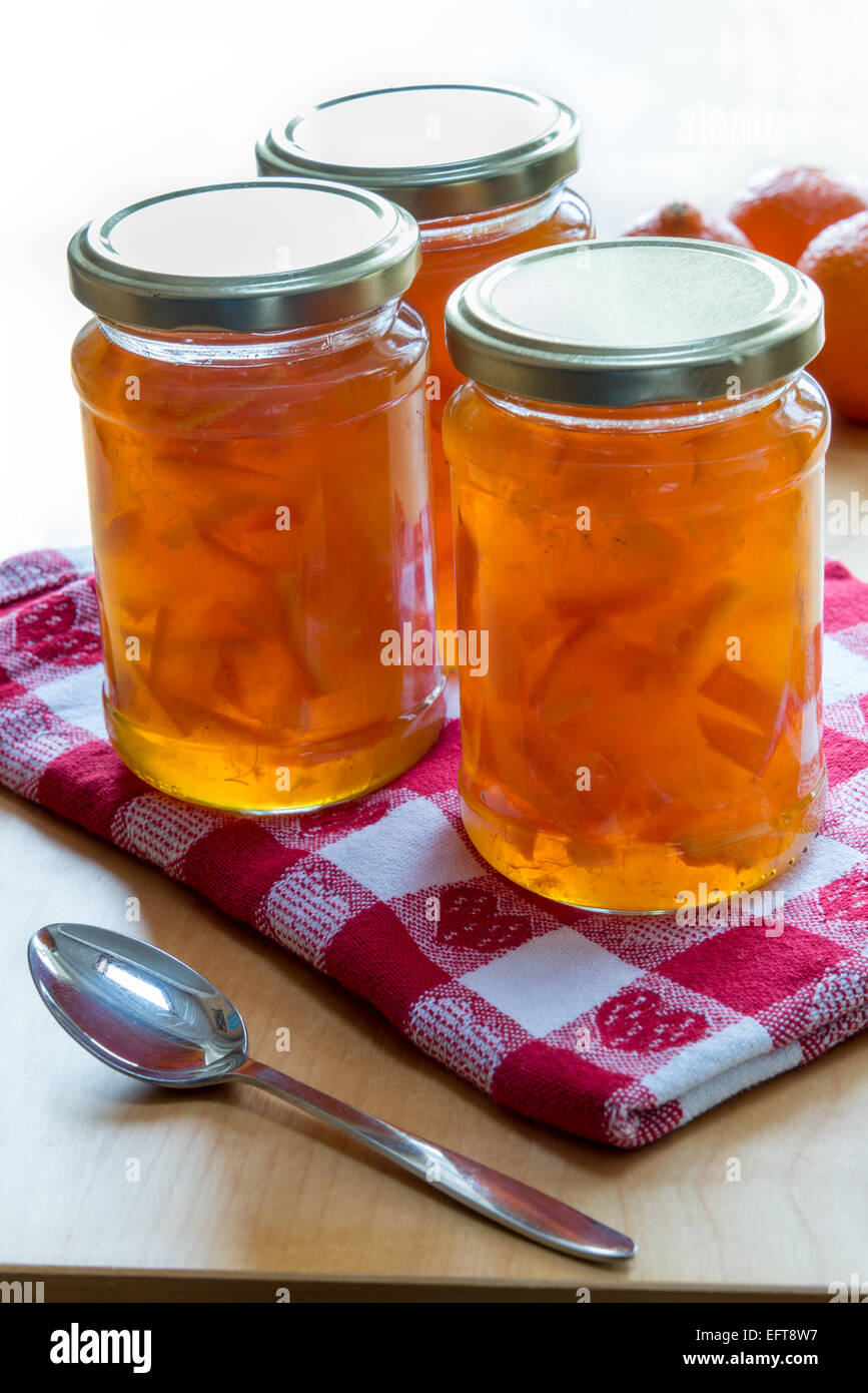 Jars of homemade Seville orange and clementine marmalade. Stock Photo