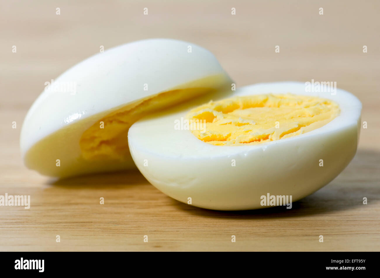 Hard boiled egg cut in half on chopping board Stock Photo Alamy