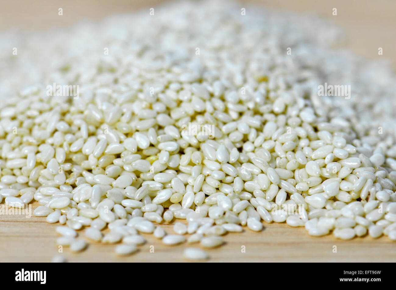 Close up of sesame seeds on chopping board Stock Photo