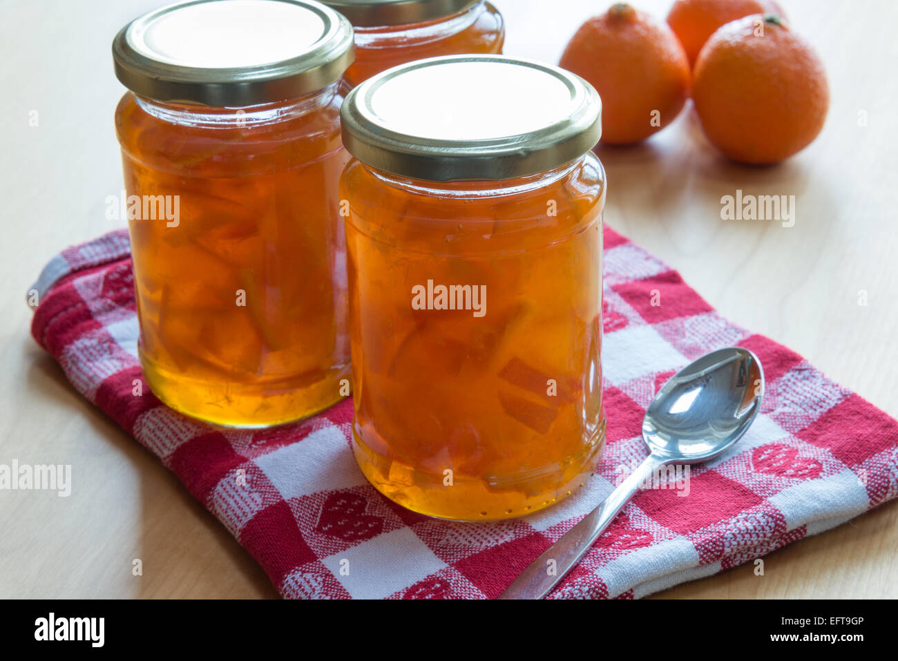 Jars of homemade Seville orange and clementine marmalade. Stock Photo