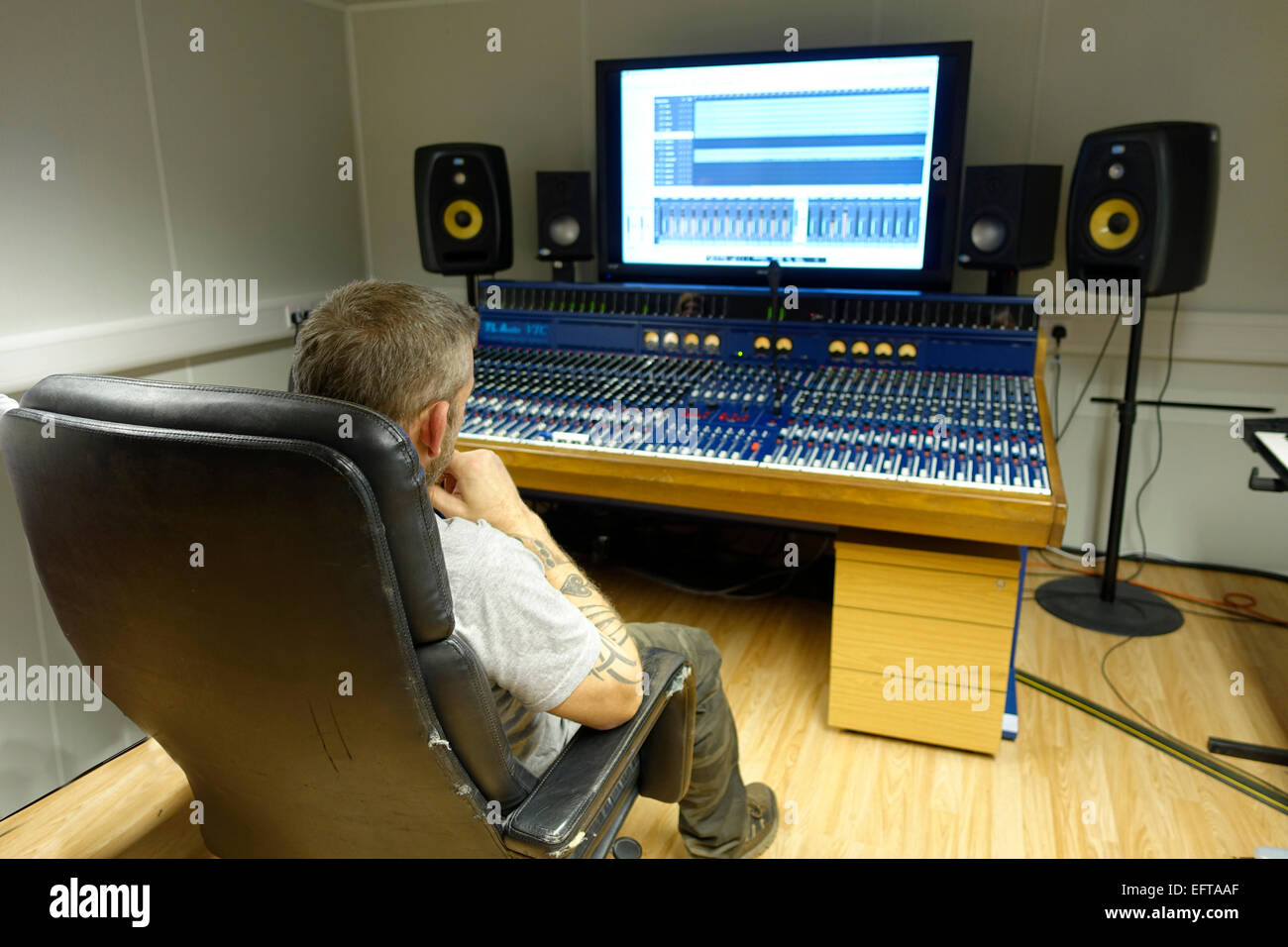 Recording Engineer listening to recording playback in sound studio Stock Photo