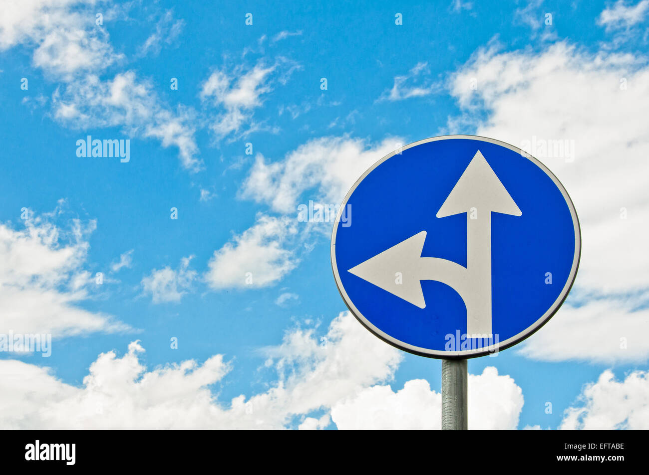 forced directions road sign with cloudy sky background Stock Photo - Alamy