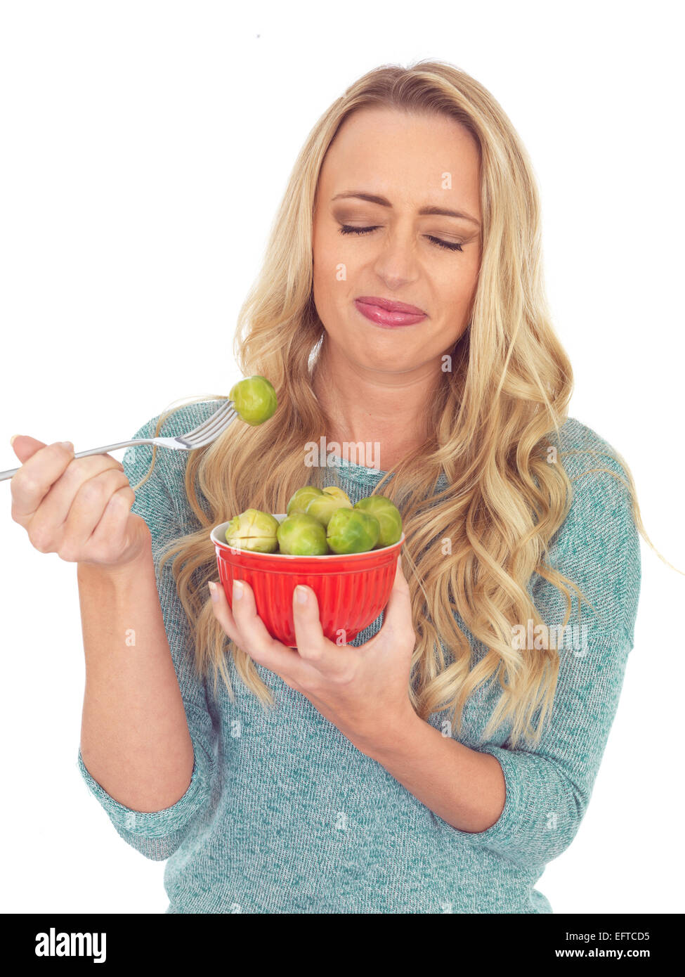 Attractive Young Woman Holding a Bowl of Brussels Sprouts Stock Photo